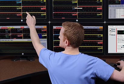 A caregiver is monitoring hospital data via GE Healthcare monitoring system.